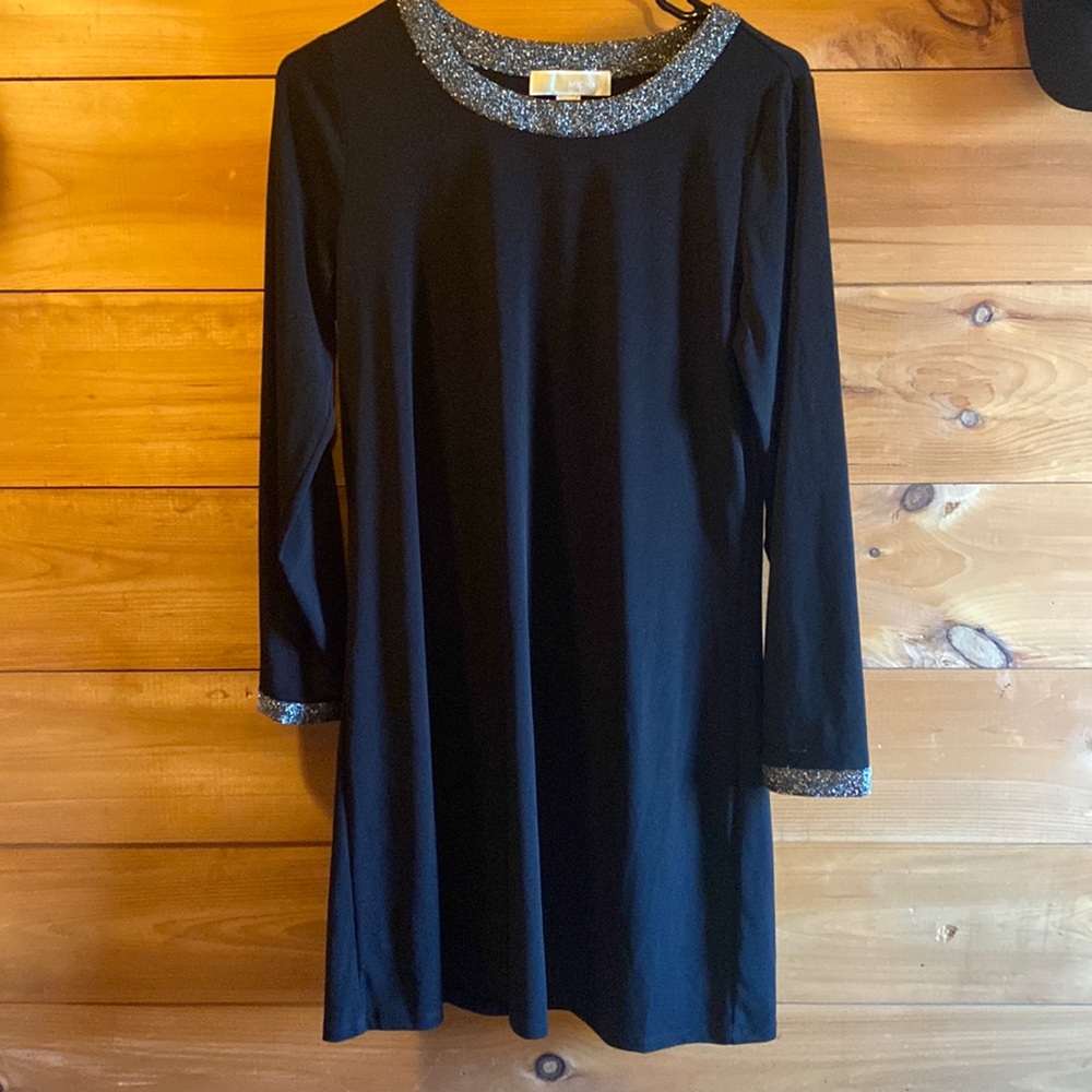 Michael Kors black dress with neck and sleeve accents. Mid thigh height